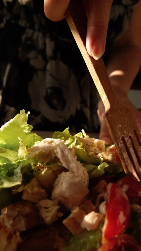 Mixing cezar salad with fork vertical video slow motion Stock Footage 155080272