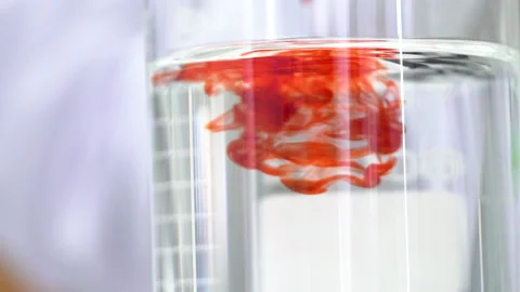 Mixing chemicals in laboratory, testing and dripping test fluid in close up, Stock Footage 147992837