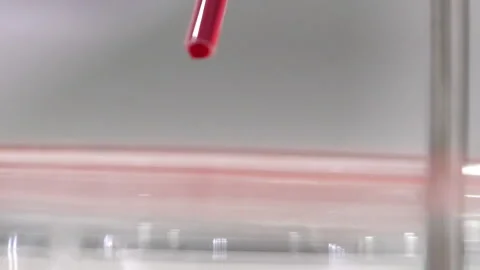 Mixing chemicals in laboratory, testing and dripping test fluid in close up Stock Footage 147995611