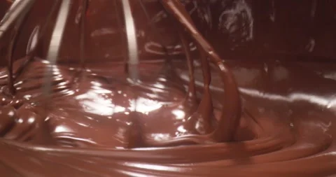 Mixing chocolate batter in a kitchen during an afternoon baking session for a Stock Footage 325100031