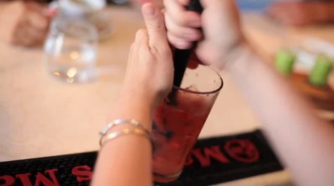 Mixing cocktail with a muddler Stock Footage 42125043
