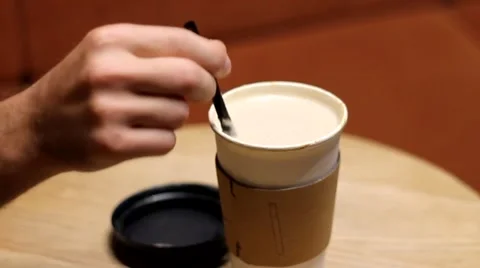 MIXING THE COFFEE ON THE TABLE IN NIGHT CAFE Video stock 65416723