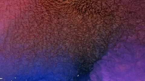 Mixing colored alcohol inks to create unique patterns in a close-up view Stock Photos