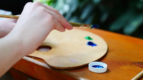 Mixing colors on the palette is essential for creating inspiring art that Stock Footage 311409175