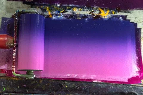 Mixing colors using a roller to roll over the ink. Stock Photos