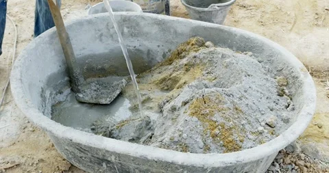 Mixing concrete for construction projects workshop tutorial industrial close-up Stock Footage 331939027