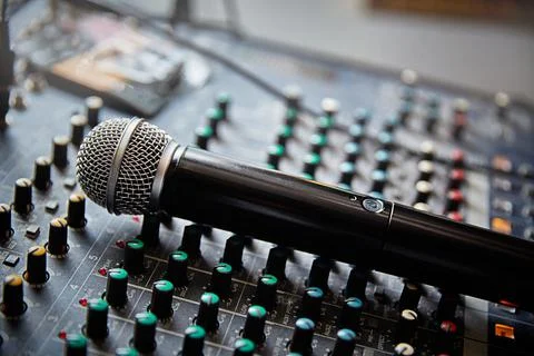 Mixing console and a new microphone close-up with a small depth of field. Stock Photos