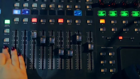 Mixing console for which women's hands are working in color lighting Stock Footage 104670726