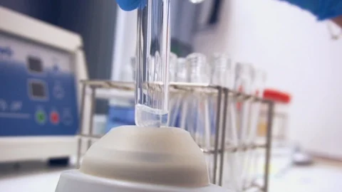 Mixing content of test tube Stock Footage 87805049