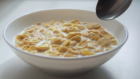 Mixing corn flakes with milk. Stock Footage 129234839