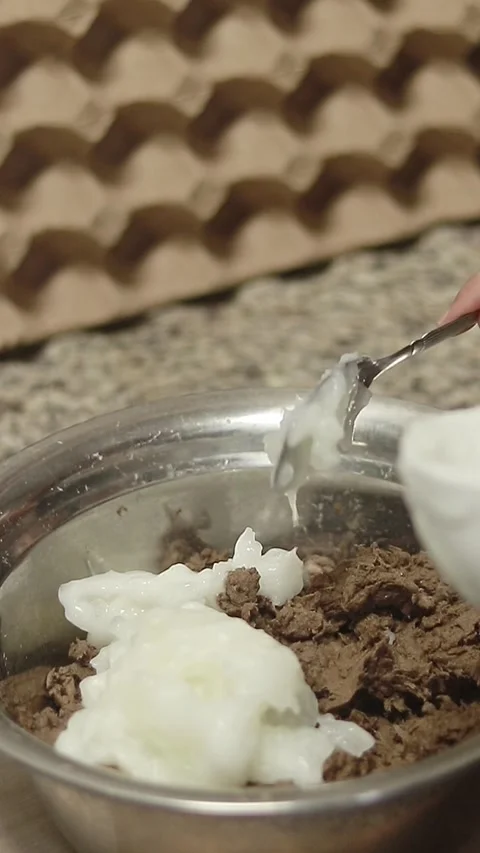 Mixing cornstarch glue to pounded egg carton in the process of making handmade a Stock Footage 311530894