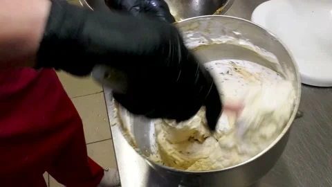 Mixing creme and chocolate chips in steel bowl UHD Stock Footage 152987967