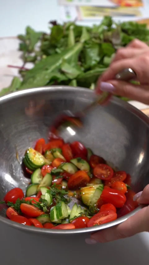 Mixing Cucumber, Tomato, and Herb Salad in Aluminum Bowl Stock Footage 288919676