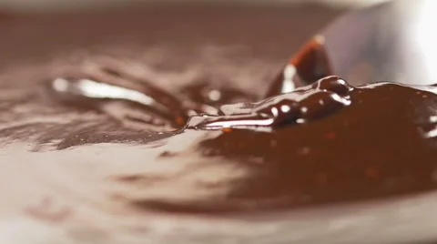 Mixing delicious melted chocolate with a spoon in slow motion Stock Footage 59665593