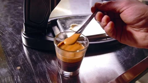 Mixing dense crema of Espresso using spoon Stockbeeldmateriaal 149417568