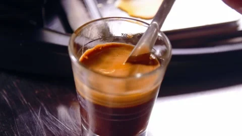 Mixing dense crema of Espresso using spoon close up Stockbeeldmateriaal 149417622