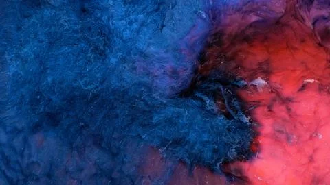 Mixing different colored alcohol inks in a close-up view Stock Photos