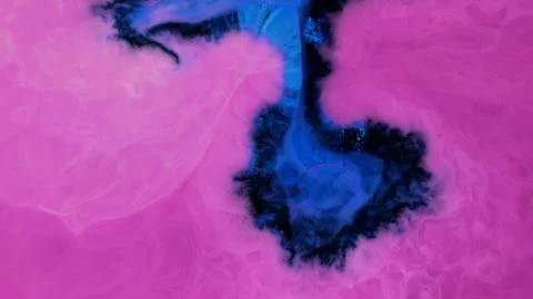 Mixing different colored alcohol inks in a close-up view Stock Photos