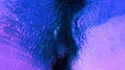 Mixing different colored alcohol inks in a close-up view Stock Photos