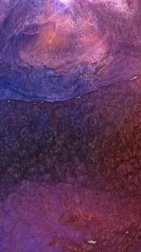 Mixing different colored alcohol inks in a close-up view Stock Photos