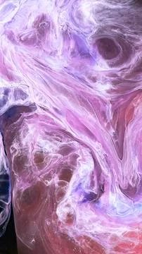 Mixing different colored alcohol inks in a close-up view Stock Photos