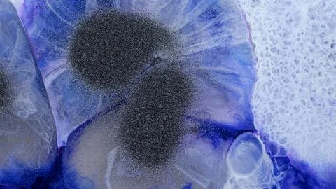 Mixing different colored alcohol inks and epoxy resin in close-up view Stock Photos