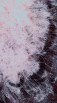 Mixing different colored alcohol inks in an abstract pattern Stock Photos