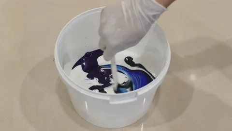 Mixing different paints in buckets Stock Footage 131096111