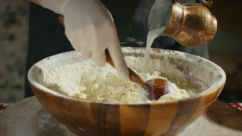 Mixing dough and adding milk Stock Footage 138127068