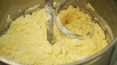 Mixing a dough for bread baking with professional kneader spiral machine at the Stock-Footage 93058947