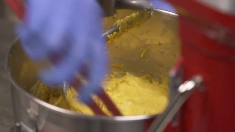 Mixing a dough for bread baking with professional kneader spiral machine at the Stock Footage 106247864