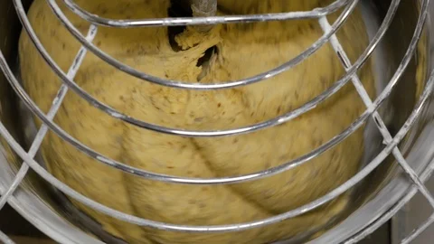 Mixing a dough for bread baking with professional kneader spiral machine Stock Footage 108095727
