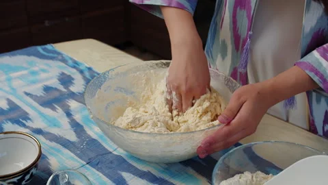 Mixing dough by hand in kitchen Stock Footage 317528438