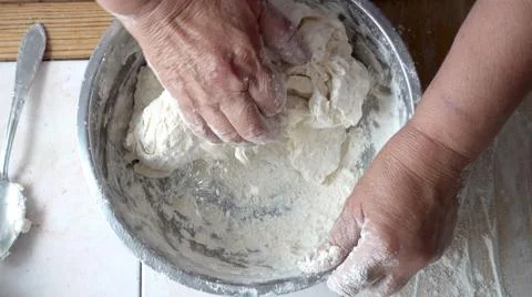 Mixing the dough in a metal bowl Stock Photos