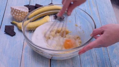 Mixing Egg and Sugar with Mashed Bananas for Banana Bread Stock Footage 322926425