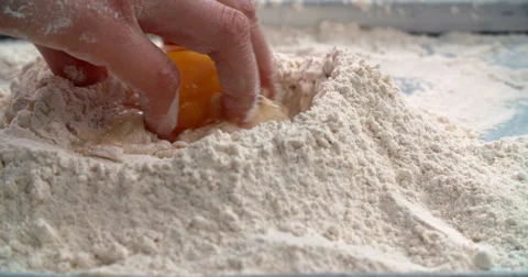 Mixing egg into flour Stock Footage 58299595