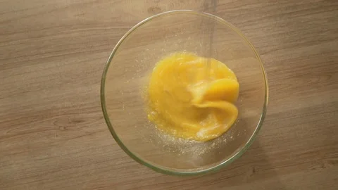 Mixing eggs, beating eggs slow motion Stock-Footage 124673888