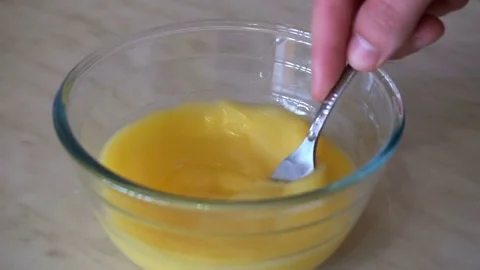 Mixing eggs in bowl with a fork Stock Footage 77404393