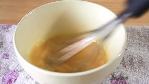 Mixing Eggs in a Bowl with Whisk Stock Footage 85567460
