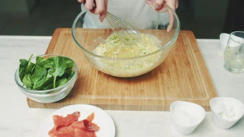 Mixing Eggs with Chopped Zucchini Stock Footage 304876058