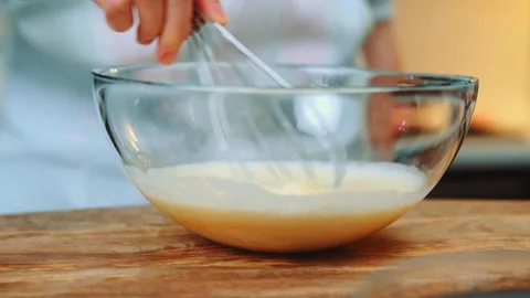 Mixing eggs with a hand whisk Stock-Footage 249079525