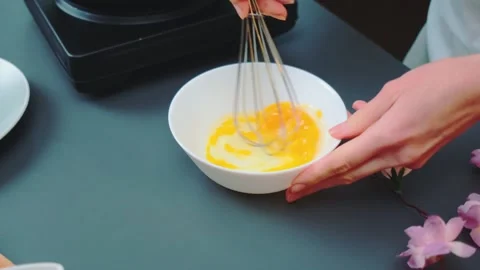 Mixing eggs into an omelet on the table Stock-Footage 252441035