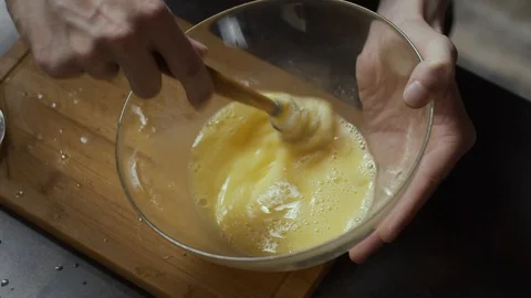 Mixing eggs in plate Stock Footage 125948825