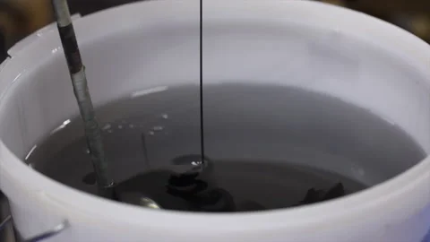 Mixing epoxy resin components with dye. Stock Footage 183915531