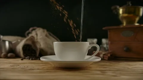 Mixing falling instant coffee granules with pouring boiled water flow in white Stock Footage 135401051