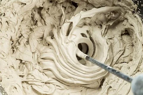 Mixing of filler in a bucket Stock Photos