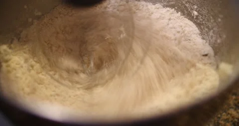 Mixing flour and different ingredients and mixing bowl blender close up Stock Footage 217355571
