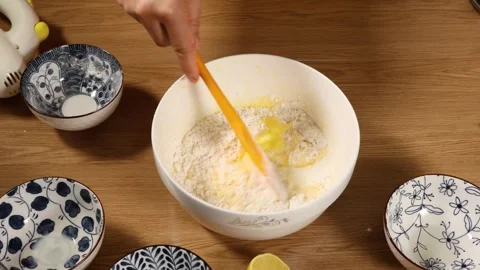 Mixing Flour and Egg Mixture in Ceramic Bowl with Chopsticks Stock Footage 340775358