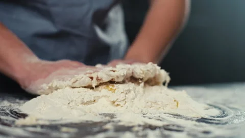 Mixing flour and eggs for making dough close-up. Stock Footage 240404122