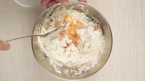 Mixing Flour Into Chicken and Egg With a Fork Stock-Footage 343304064